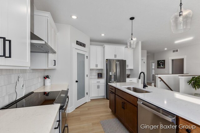5560 Albright Ave SW Unit 67, Wyoming, MI 49418 - kitchen featuring visible vents, appliances with stainless steel finishes, white cabinetry, a sink, and pendant lighting