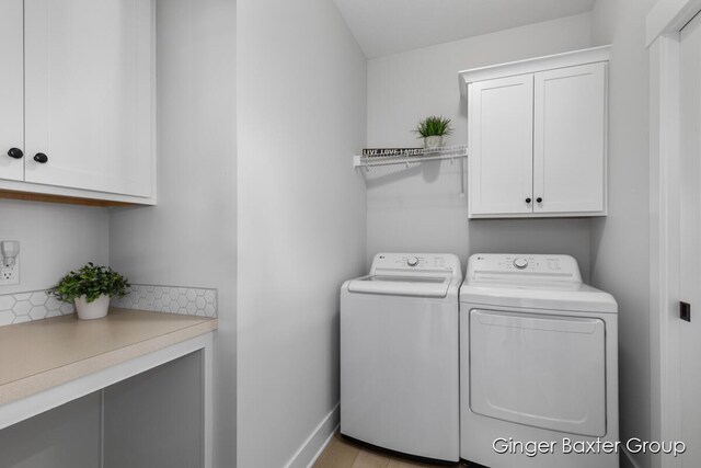5560 Albright Ave SW Unit 67, Wyoming, MI 49418 - laundry room with baseboards, separate washer and dryer, and cabinet space