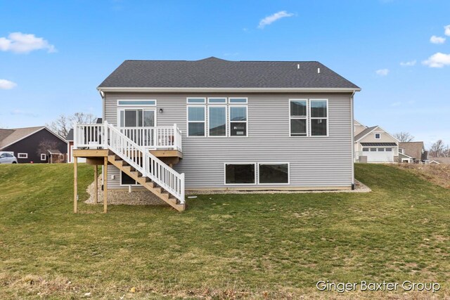 5560 Albright Ave SW Unit 67, Wyoming, MI 49418 - rear view of house featuring a lawn, stairs, a shingled roof, and a wooden deck