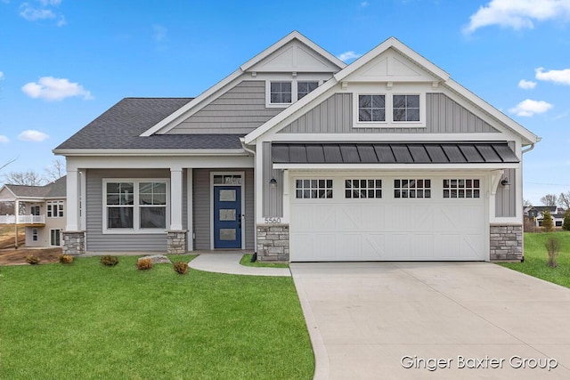 5560 Albright Ave SW Unit 67, Wyoming, MI 49418 - craftsman house featuring driveway, a front yard, stone siding, board and batten siding, and a garage