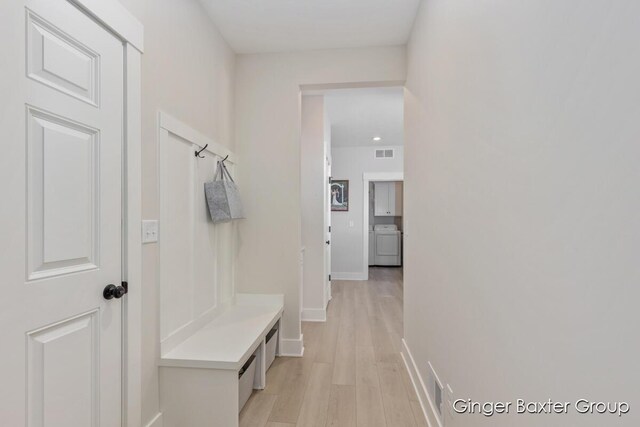 5560 Albright Ave SW Unit 67, Wyoming, MI 49418 - mudroom with light wood finished floors, baseboards, visible vents, and washer / clothes dryer