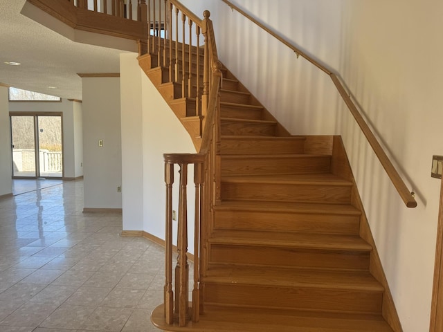stairs with baseboards and tile patterned flooring