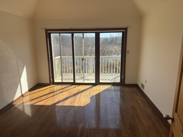 unfurnished room with vaulted ceiling, plenty of natural light, and visible vents
