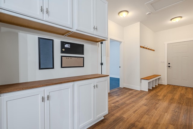 3935 W Destiny Dr, Hart, MI 49420 - kitchen featuring butcher block countertops, white cabinetry, baseboards, and wood finished floors