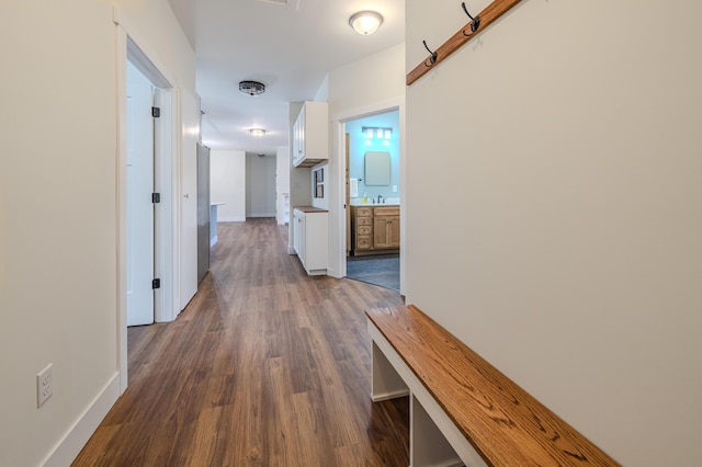 3935 W Destiny Dr, Hart, MI 49420 - corridor with dark wood finished floors, baseboards, and a sink