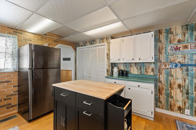 1169 Shady Shores Dr, Niles, MI 49120 - kitchen with visible vents, freestanding refrigerator, white cabinets, a paneled ceiling, and dark cabinets