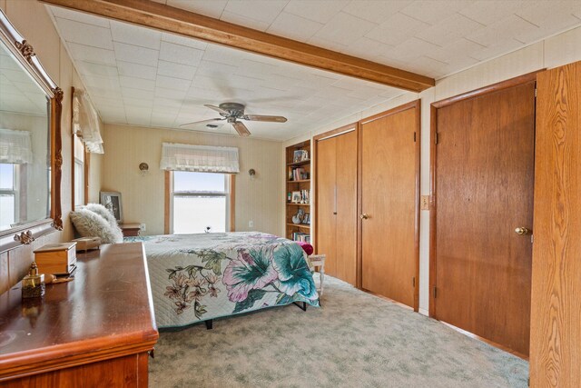 1169 Shady Shores Dr, Niles, MI 49120 - carpeted bedroom featuring beam ceiling, two closets, and a ceiling fan