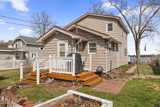1169 Shady Shores Dr, Niles, MI 49120 - bungalow-style home with a front lawn, fence, and a wooden deck