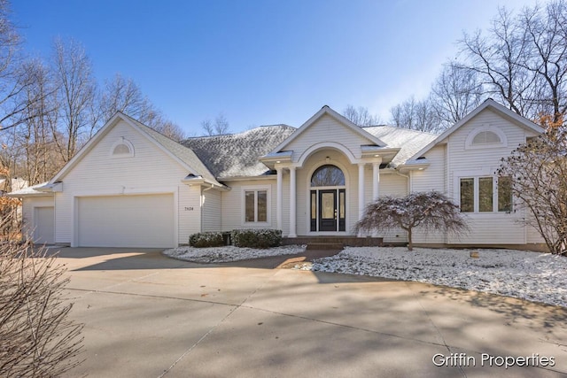 7834 Strawberry Ln NE, Belmont, MI 49306 - view of front facade with concrete driveway, a garage, and a shingled roof