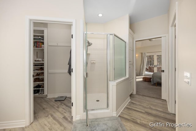 7834 Strawberry Ln NE, Belmont, MI 49306 - ensuite bathroom featuring a shower stall, wood finished floors, and ensuite bathroom