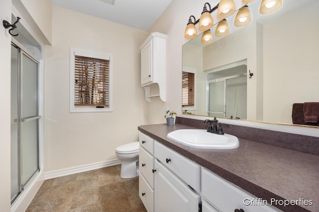 7834 Strawberry Ln NE, Belmont, MI 49306 - full bathroom featuring baseboards, toilet, a stall shower, and vanity