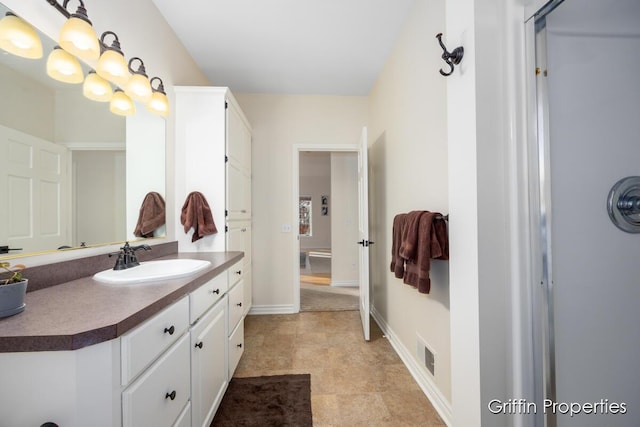 7834 Strawberry Ln NE, Belmont, MI 49306 - bathroom with vanity, baseboards, and visible vents