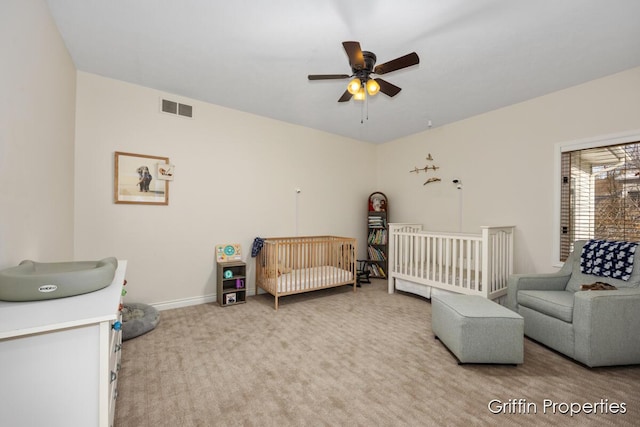 7834 Strawberry Ln NE, Belmont, MI 49306 - carpeted bedroom featuring a nursery area, baseboards, visible vents, and ceiling fan