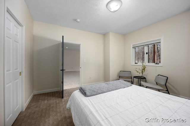 7834 Strawberry Ln NE, Belmont, MI 49306 - carpeted bedroom with a textured ceiling and baseboards
