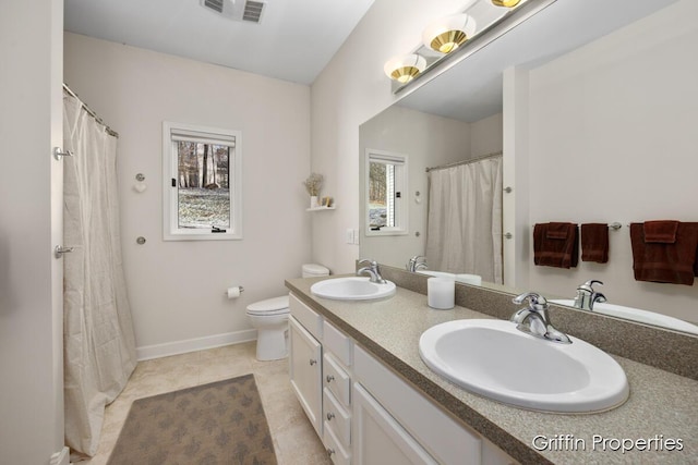 7834 Strawberry Ln NE, Belmont, MI 49306 - full bath with tile patterned floors, toilet, visible vents, and a sink