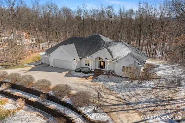 7834 Strawberry Ln NE, Belmont, MI 49306 - view of front of house featuring stucco siding, concrete driveway, an attached garage, and a shingled roof