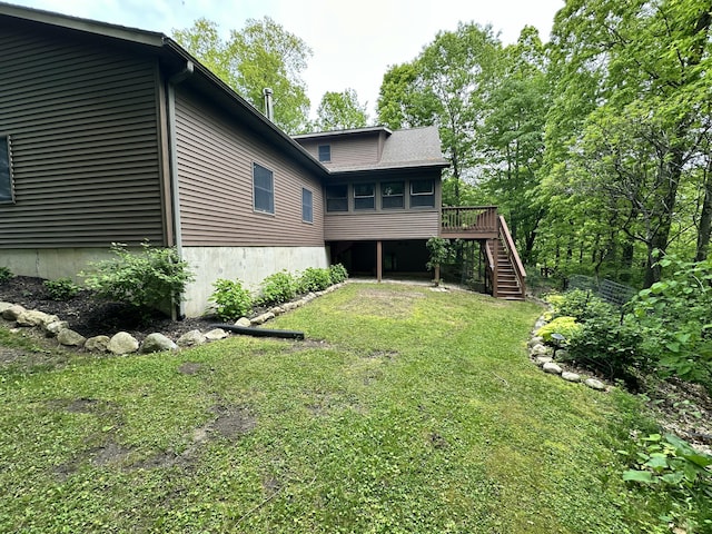 8440 S Felch Ave, Newaygo, MI 49337 - rear view of house with stairs, a lawn, a sunroom, and a wooden deck