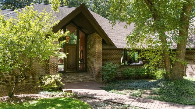 4923 Hickory Hill Rd, Ann Arbor, MI 48105 - property entrance featuring brick siding and roof with shingles