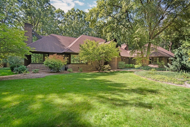4923 Hickory Hill Rd, Ann Arbor, MI 48105 - view of front of property featuring a shingled roof, a chimney, and a front yard