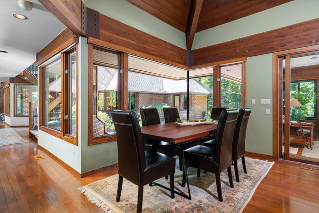 4923 Hickory Hill Rd, Ann Arbor, MI 48105 - dining space with hardwood / wood-style floors, visible vents, lofted ceiling, and baseboards
