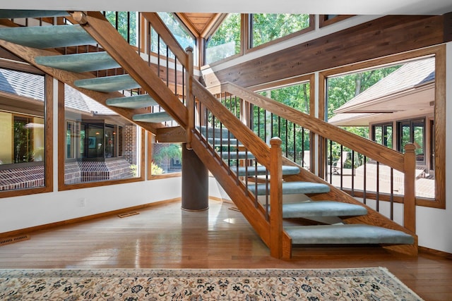 4923 Hickory Hill Rd, Ann Arbor, MI 48105 - stairs with baseboards, visible vents, and wood-type flooring