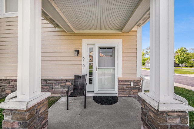 616 Boardwalk Ln, Dexter, MI 48130 - doorway to property featuring a porch and stone siding