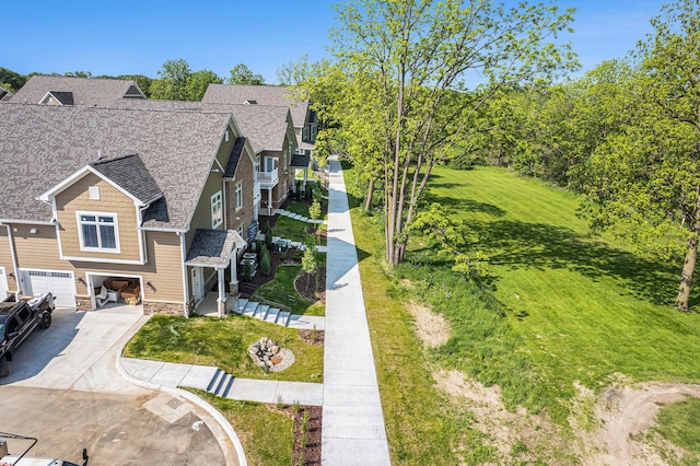 616 Boardwalk Ln, Dexter, MI 48130 - view of front of property with an attached garage, concrete driveway, roof with shingles, stone siding, and a front lawn