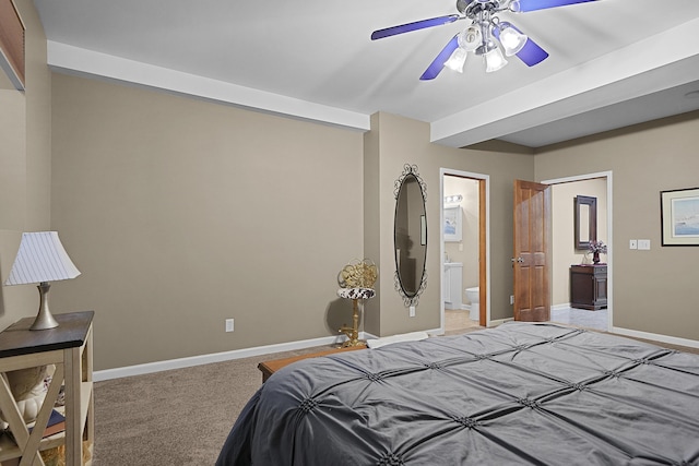 bedroom with connected bathroom, baseboards, light carpet, and ceiling fan