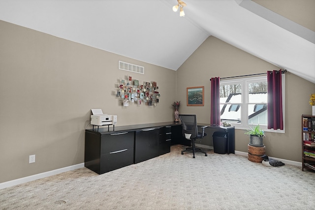 carpeted home office with visible vents, baseboards, and vaulted ceiling