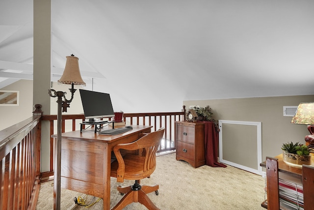 home office with visible vents, lofted ceiling, and light colored carpet