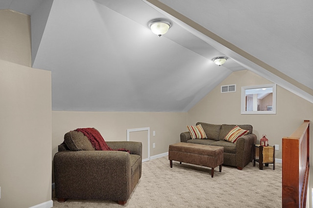 carpeted living area featuring visible vents, baseboards, and vaulted ceiling