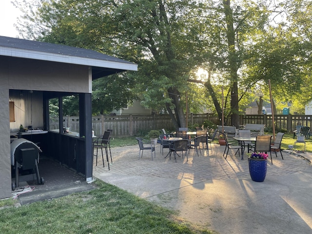 view of patio / terrace with outdoor dining area, a fenced backyard, and a grill