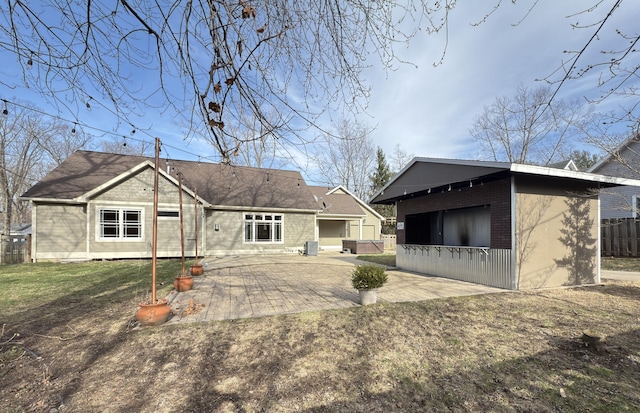 back of property featuring brick siding, fence, central AC, a patio area, and an outbuilding