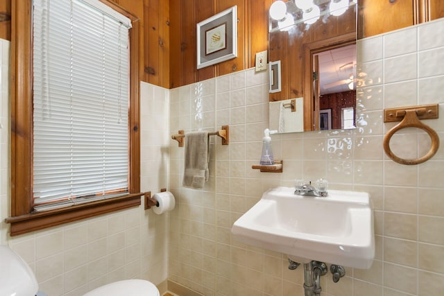 36.5 Lake Shore Dr, South Haven, MI 49090 - bathroom with a sink, decorative backsplash, toilet, and tile walls