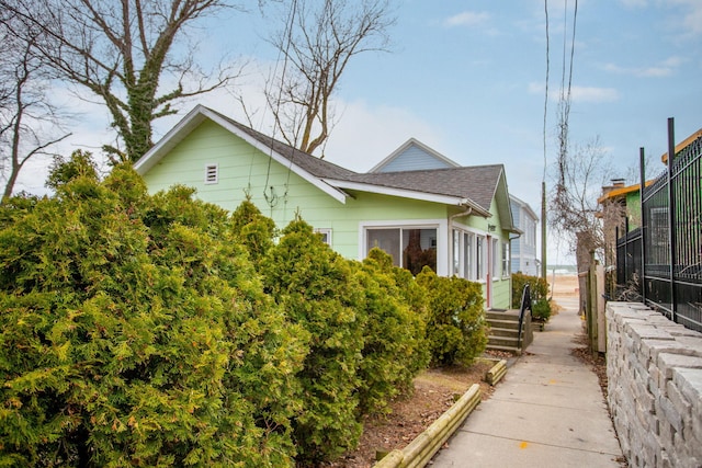 36.5 Lake Shore Dr, South Haven, MI 49090 - view of property exterior with fence and roof with shingles