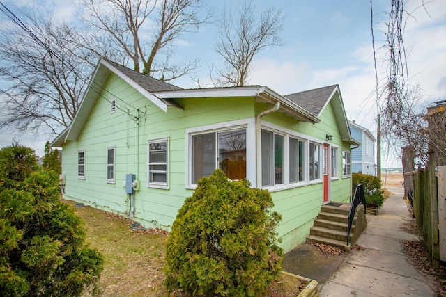 36.5 Lake Shore Dr, South Haven, MI 49090 - view of side of home featuring a shingled roof and fence