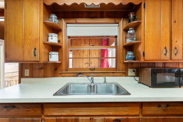 36.5 Lake Shore Dr, South Haven, MI 49090 - kitchen with black microwave, light countertops, a sink, and open shelves