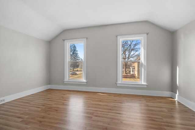 816 7th St, Three Rivers, MI 49093 - additional living space featuring light wood-style flooring, baseboards, and vaulted ceiling