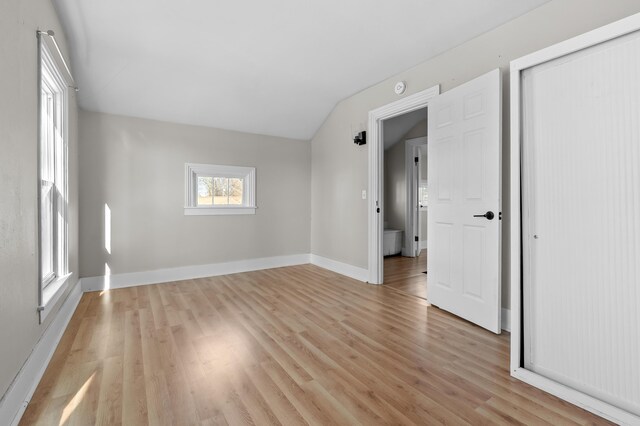 816 7th St, Three Rivers, MI 49093 - empty room featuring vaulted ceiling, light wood-style flooring, and baseboards