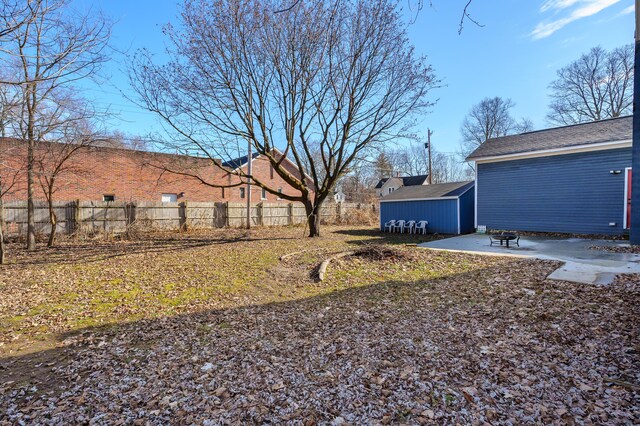 816 7th St, Three Rivers, MI 49093 - view of yard featuring an outdoor structure, a storage shed, a patio, and fence