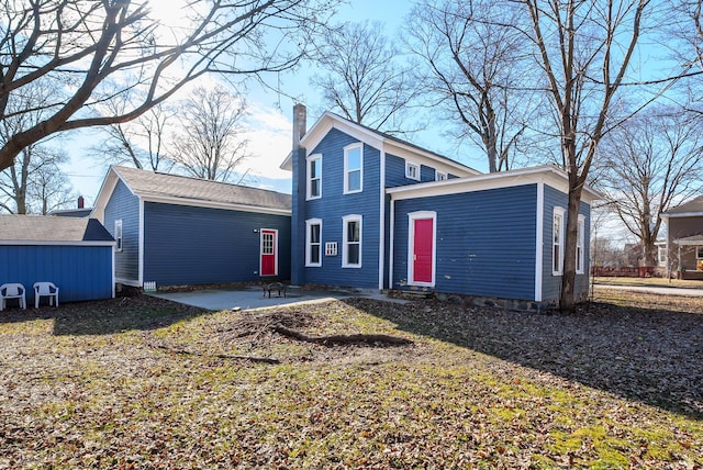 816 7th St, Three Rivers, MI 49093 - back of property featuring a patio and a chimney