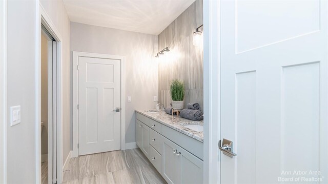 1303 Gallery Pointe Dr, Saline, MI 48176 - bathroom with a sink, baseboards, and double vanity