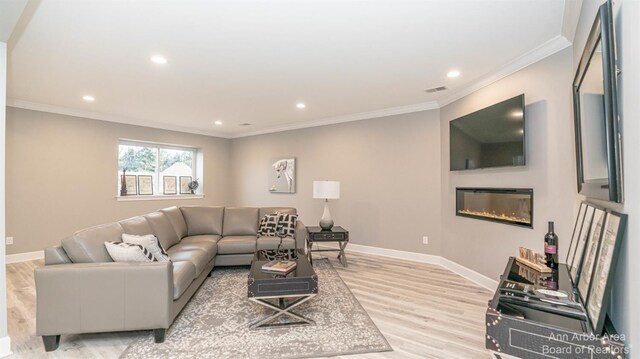 1303 Gallery Pointe Dr, Saline, MI 48176 - living room featuring a glass covered fireplace, light wood-type flooring, baseboards, and ornamental molding