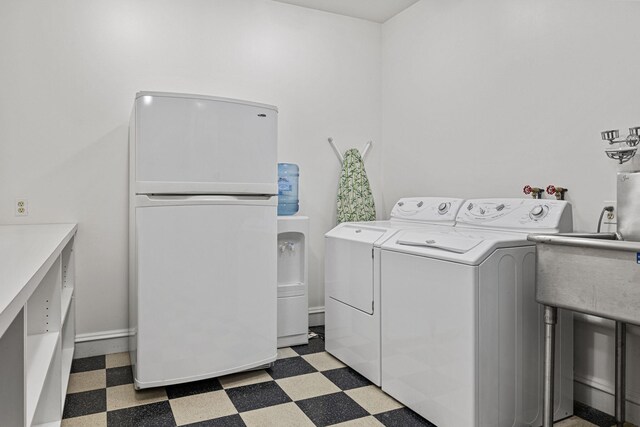 5716 E 1000 N, La Porte, IN 46350 - laundry room featuring baseboards, washer and dryer, laundry area, and light floors