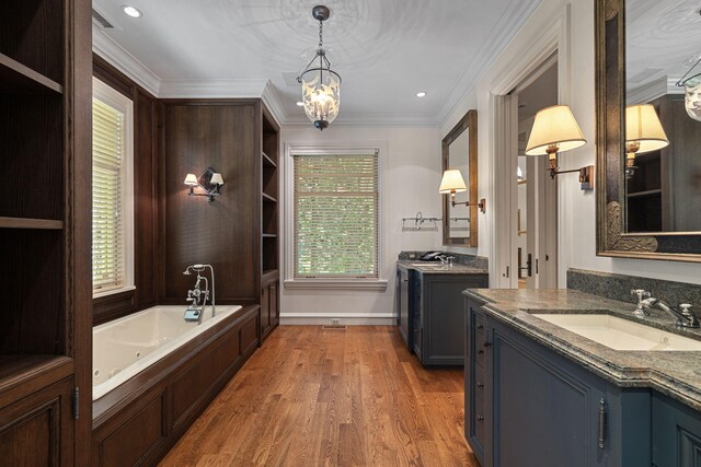 5716 E 1000 N, La Porte, IN 46350 - bathroom featuring a notable chandelier, a sink, two vanities, wood finished floors, and ornamental molding