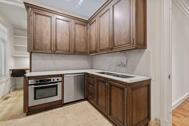 5716 E 1000 N, La Porte, IN 46350 - kitchen with light countertops, stainless steel appliances, dark brown cabinets, a sink, and backsplash