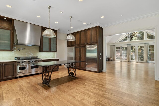 5716 E 1000 N, La Porte, IN 46350 - kitchen with crown molding, wall chimney exhaust hood, dark brown cabinets, high quality appliances, and backsplash