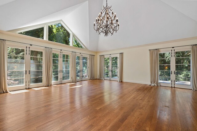 5716 E 1000 N, La Porte, IN 46350 - unfurnished living room featuring wood finished floors, french doors, and a chandelier