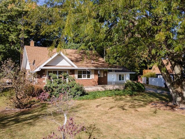 5844 S Scottdale Rd, Berrien Springs, MI 49103 - single story home with brick siding, fence, a front lawn, and a chimney
