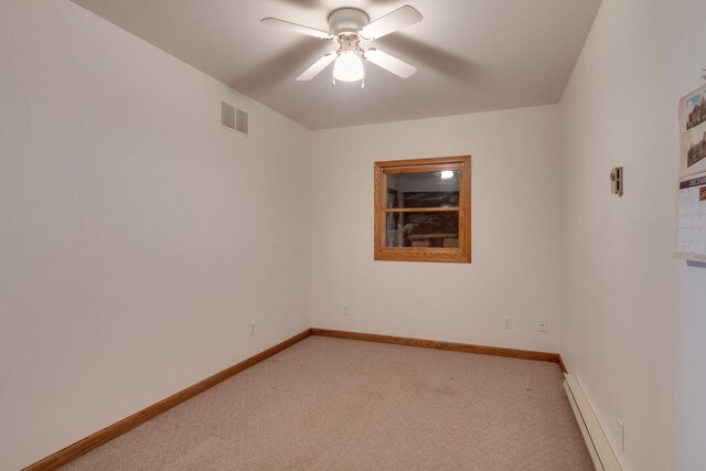 5844 S Scottdale Rd, Berrien Springs, MI 49103 - spare room with a baseboard radiator, baseboards, light colored carpet, visible vents, and ceiling fan